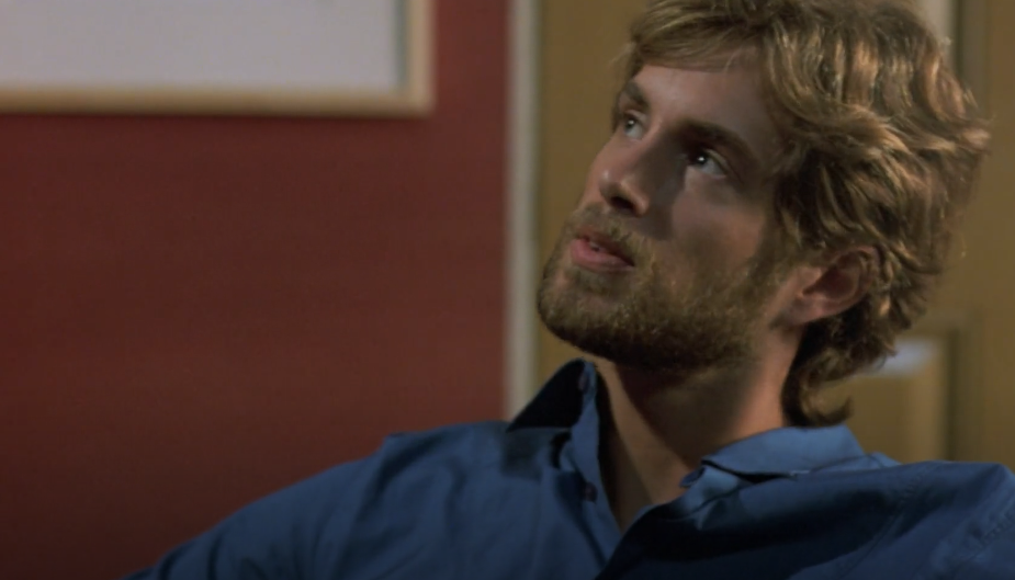Mark from The Room looks clueless. Offscreen, his best friend's fiancée is hitting on him.